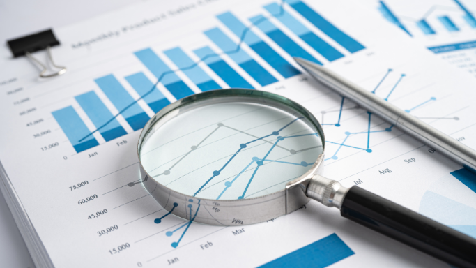Financial data charts analyzed with a magnifying glass to support informed decisions